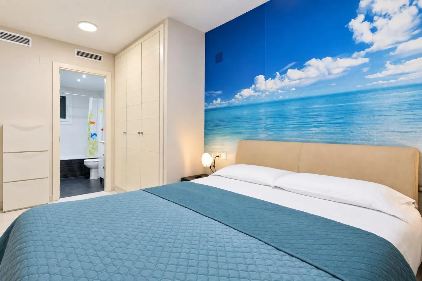 Dormitorio con mural de playa